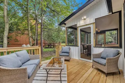 a screened in porch with chairs and a table at Luxury Hot Tub Game Room and More in Albrightsville
