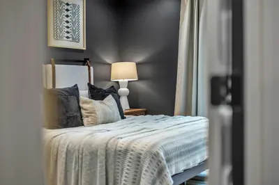 a bedroom with a bed with pillows and a lamp at Luxury Hot Tub Game Room and More in Albrightsville