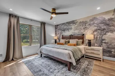 a bedroom with a bed and a large painting on the wall at Luxury Hot Tub Game Room and More in Albrightsville