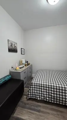 a bedroom with a bed and a dresser at Serenity Haven in Irvington