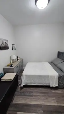 a bedroom with a bed and a couch at Serenity Haven in Irvington