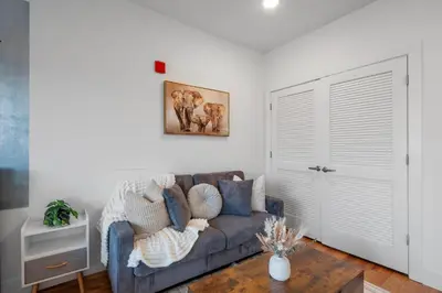 a living room with a couch and a table at Skyline Studio - Modern Comfort Pool Access in Philadelphia