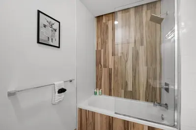 a bathroom with a shower with a glass door at Skyline Studio - Modern Comfort Pool Access in Philadelphia