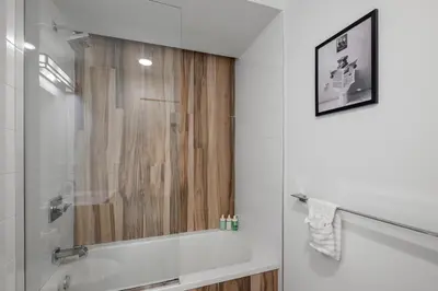 a bathroom with a shower with a glass door at Luxury 1BR Loft - Skyline Views Pool Access in Philadelphia