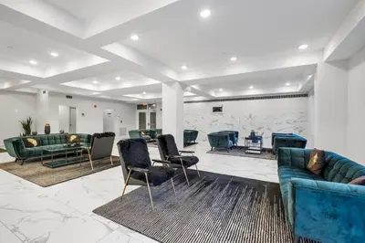 a lobby with couches and chairs in a room at Luxury 1BR Loft - Skyline Views Pool Access in Philadelphia