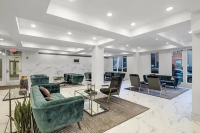 a lobby with couches and chairs in a building at Luxury 1BR Loft - Skyline Views Pool Access in Philadelphia