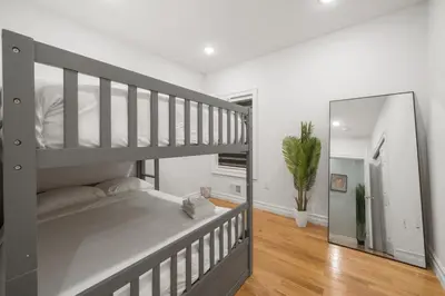 a bedroom with a bunk bed and a mirror at Skyline Haven Luxe NYC Escape in Jersey City