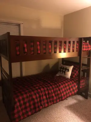 a bunk bed with a checkered blanket and a pillow at Chalet in Masthope Community in Lackawaxen