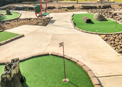 a miniature golf course in a garden with a chair at Chalet in Masthope Community in Lackawaxen