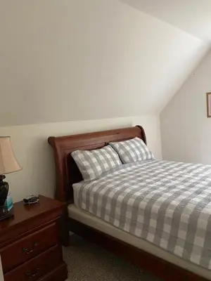 a bedroom with a bed and a table with a lamp at Chalet in Masthope Community in Lackawaxen