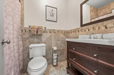a bathroom with a toilet and a sink at HUGE Cozy Jersey City Oasis with Double Balcony - 20 mins to NYC in Jersey City