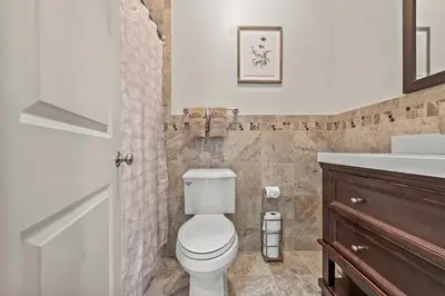 a bathroom with a toilet and a sink at HUGE Cozy Jersey City Oasis with Double Balcony - 20 mins to NYC in Jersey City