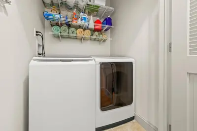 a washing machine in a kitchen with a sink at HUGE Cozy Jersey City Oasis with Double Balcony - 20 mins to NYC in Jersey City