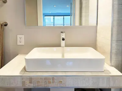 a white sink in a bathroom with a mirror at Gallery Suite in Art Tower in Philadelphia