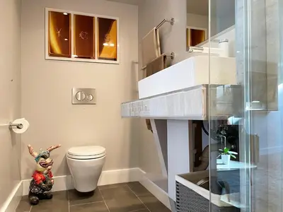 a bathroom with a toilet and a stair case at Gallery Suite in Art Tower in Philadelphia