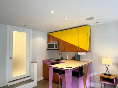 a kitchen with a table and a microwave at Gallery Suite in Art Tower in Philadelphia