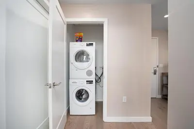 a laundry room with a washer and dryer at Midtown View - Minutes to City in Hoboken