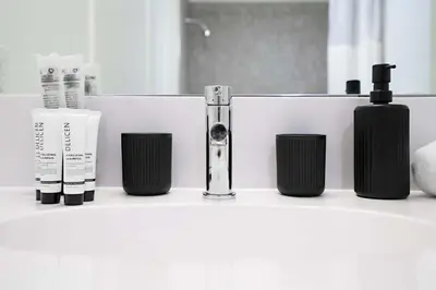 a bathroom counter with several products on it at Exclusive 1BR Apt with NYC View in Hoboken