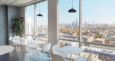 a room with tables and chairs and a large window at Exclusive 1BR Apt with NYC View in Hoboken