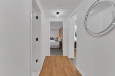 a hallway with a mirror and a bedroom at Fire and Fun Luxe Stay w Pool Hot Tub and Game Room in Linden