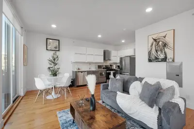 a living room with a couch and a table at Courtyard Studio - Serene Space Gym Wi-Fi in Philadelphia