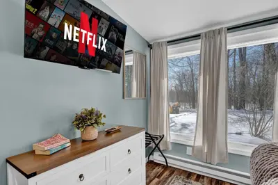 a bedroom with a desk and a window at Palomino Ranch namaste-sunroom, hot tub, game room, king beds, fire pit, BBQ, pet-friendly in Tobyhanna