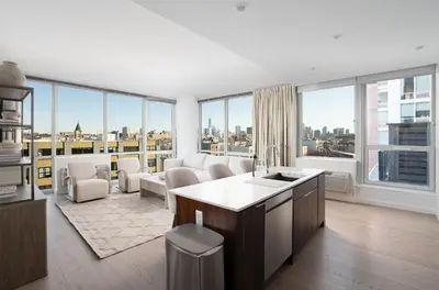 a kitchen and living room with a view of the city at Ultra Luxury Apt - Panoramic NYC View - Minutes to City in Hoboken