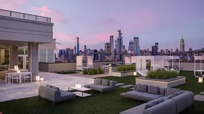 a rooftop patio with a view of a city at Ultra Luxury Apt - Panoramic NYC View - Minutes to City in Hoboken