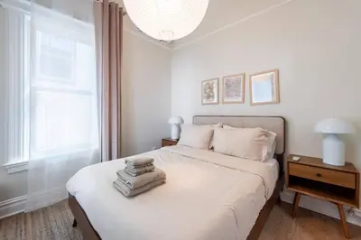 a bedroom with a white bed and a window at Bright & Modern - 35 Mins to NYC - Extended Stays in Jersey City