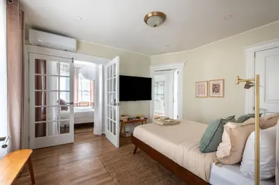 a bedroom with a bed and a television in it at Bright & Modern - 35 Mins to NYC - Extended Stays in Jersey City