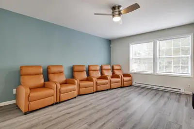 a waiting room with leather chairs and a ceiling fan at Spacious 5BR Home In Heart Of Poconos By Camelback Skiing Swimming Lake in Tobyhanna