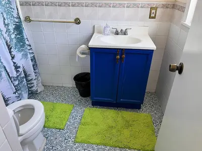 a bathroom with a blue sink and a toilet at Amazing three bedrooms Apartment near EWR and NYC in Linden