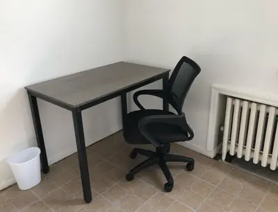 a black desk with a chair in a room at Private house with 3 bedrooms and 1 bathroom, free parking, convenient to NYC Manhattan bus and train, MetLife Stadium FIFA World Cup 35 minutes away in Perth Amboy