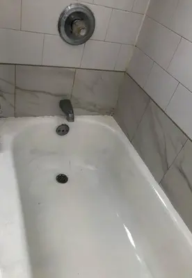 a white bath tub with a faucet in a bathroom at Private house with 3 bedrooms and 1 bathroom, free parking, convenient to NYC Manhattan bus and train, MetLife Stadium FIFA World Cup 35 minutes away in Perth Amboy