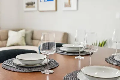 a table with plates and wine glasses on it at Chic & Modern - 30 Mins to NYC in Jersey City