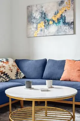 a living room with a blue couch and a coffee table at Chic & Modern - 35 Mins to NYC - Extended Stays in Jersey City