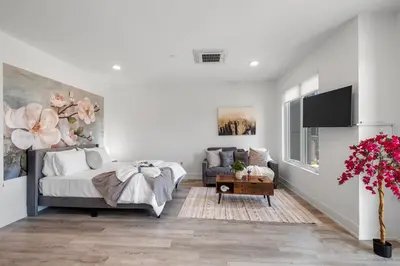 a white bedroom with a bed and a couch at Cozy Luxe Studio - Workstation WasherDryer in Philadelphia