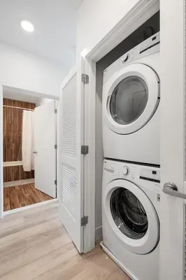 a white laundry room with a washer and dryer at Cozy Luxe Studio - Workstation WasherDryer in Philadelphia