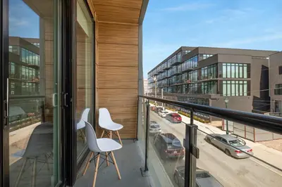 a balcony with two chairs and a view of a city at Urban Retreat Studio - Balcony Smart Design in Philadelphia