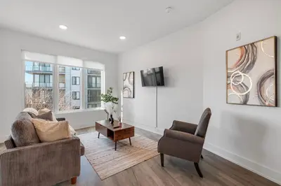a living room with two chairs and a tv at Urban Retreat Studio - Balcony Smart Design in Philadelphia