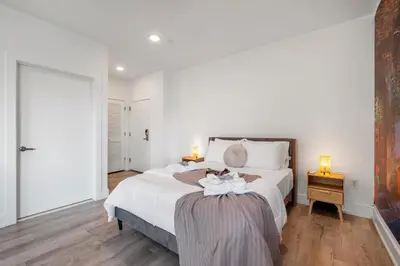 a bedroom with a bed with two towels on it at Urban Retreat Studio - Balcony Smart Design in Philadelphia