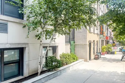 a building on a city street with a tree at Murray Hill Studio w Gym Doorman nr 6 train NYC-628 in New York