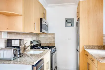 a kitchen with a stove and a sink at Murray Hill Studio w Gym Doorman nr 6 train NYC-628 in New York
