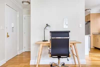 a desk with a chair in a room at Murray Hill Studio w Gym Doorman nr 6 train NYC-628 in New York