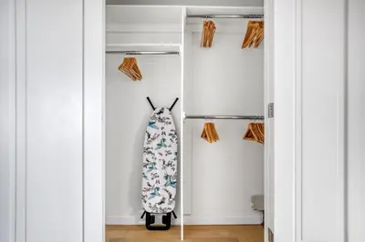 a room with a closet with a dress and a bag at Tribeca Studio w City views Gym Pool NYC-110 in New York