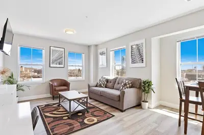 a living room with a couch and a table at Downtown NWK 1BR- Free Parking Easy NYC Access in Newark