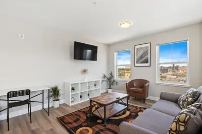 a living room with a couch and a table at Downtown NWK 1BR- Free Parking Easy NYC Access in Newark