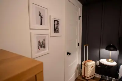 a room with a white door and pictures on the wall at Sosuite at The Jefferson - Fishtown in Philadelphia