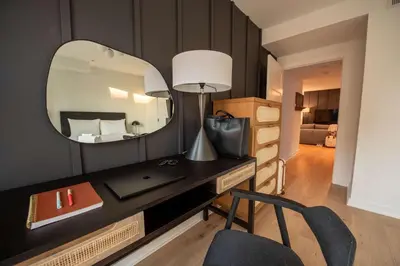 a room with a desk with a mirror and a chair at Sosuite at The Jefferson - Fishtown in Philadelphia