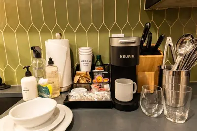 a kitchen counter with a coffee maker and other items at Sosuite at The Jefferson - Fishtown in Philadelphia